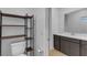 Powder room with modern shelving, toilet and contemporary vanity and sink at 9570 Thistle Creek Ave, Las Vegas, NV 89178