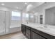 Modern bathroom featuring a double sink vanity, a glass-enclosed shower, and soaking tub at 9570 Thistle Creek Ave, Las Vegas, NV 89178