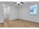 Bright bedroom with hardwood flooring and a window offering backyard views at 9570 Thistle Creek Ave, Las Vegas, NV 89178