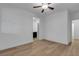Bright bedroom features hardwood floors, ceiling fan, and ensuite bathroom access at 9570 Thistle Creek Ave, Las Vegas, NV 89178