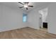 Bright and spacious bedroom with wood floors, a ceiling fan, and an ensuite bathroom at 9570 Thistle Creek Ave, Las Vegas, NV 89178