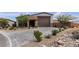 Beautiful single story home with an attached two car garage, lovely landscaping, and a paved driveway at 9570 Thistle Creek Ave, Las Vegas, NV 89178