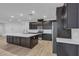 Beautiful, modern kitchen with dark cabinetry, stainless steel appliances, and a large island at 9570 Thistle Creek Ave, Las Vegas, NV 89178