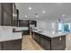 Beautiful, modern kitchen with dark cabinetry, stainless steel appliances, a large island and eat in kitchen at 9570 Thistle Creek Ave, Las Vegas, NV 89178