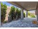 Covered patio with stone pavers, manicured landscaping, and relaxing ambiance at 9570 Thistle Creek Ave, Las Vegas, NV 89178