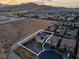 Aerial view of the property within the community, showing desert surroundings and mountain views at 9654 Starfish Reef Way, Las Vegas, NV 89178