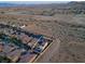 Aerial view of property and community highlighting backyard pool, solar panels, and desert landscaping at 9654 Starfish Reef Way, Las Vegas, NV 89178
