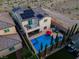 Stunning aerial view of a backyard with a sparkling pool, spa, outdoor seating, and solar panels on the home at 9654 Starfish Reef Way, Las Vegas, NV 89178