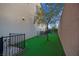 Well-maintained backyard with green artificial turf and a privacy fence, creating a serene outdoor space at 9654 Starfish Reef Way, Las Vegas, NV 89178