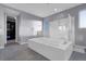 Bathroom featuring a large tub and glass enclosed shower at 9654 Starfish Reef Way, Las Vegas, NV 89178