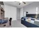 Bedroom with ceiling fan, carpet floors, large bed and desk at 9654 Starfish Reef Way, Las Vegas, NV 89178