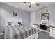 Bedroom with ceiling fan, carpet floors, large bed and desk at 9654 Starfish Reef Way, Las Vegas, NV 89178