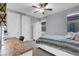 Bedroom with ceiling fan, carpet floors, large bed and desk at 9654 Starfish Reef Way, Las Vegas, NV 89178