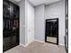 Walk-in closet featuring black cabinets with glass doors and carpet floors at 9654 Starfish Reef Way, Las Vegas, NV 89178
