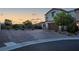 Attractive brick driveway and desert landscaping leading up to the two-story home with a two car garage at 9654 Starfish Reef Way, Las Vegas, NV 89178