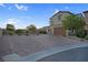 Charming home exterior featuring a manicured front yard and a spacious brick driveway at 9654 Starfish Reef Way, Las Vegas, NV 89178