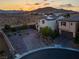 Aerial view of property showcasing desert landscaping, solar panels, and attractive brick driveway at 9654 Starfish Reef Way, Las Vegas, NV 89178
