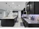 Spacious kitchen with stainless appliances, a large center island and dark cabinetry at 9654 Starfish Reef Way, Las Vegas, NV 89178