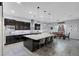 Open-concept kitchen with dark cabinets, granite countertops, and stainless steel appliances at 9654 Starfish Reef Way, Las Vegas, NV 89178