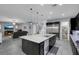 Open concept kitchen and living area with a large island and stainless steel appliances at 9654 Starfish Reef Way, Las Vegas, NV 89178