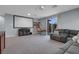 Large living room featuring a projector screen and a comfortable sectional sofa for entertaining at 9654 Starfish Reef Way, Las Vegas, NV 89178