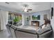 Living room has a fireplace, ceiling fan, and a view of the backyard patio at 9654 Starfish Reef Way, Las Vegas, NV 89178