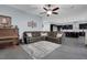 Living area has a large sectional sofa, piano, and opens into the kitchen at 9654 Starfish Reef Way, Las Vegas, NV 89178