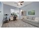 Home office with desk, sofa, and exercise bike, offering a functional workspace at 9654 Starfish Reef Way, Las Vegas, NV 89178