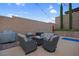 Cozy patio with comfortable seating arranged around a fire pit, perfect for outdoor gatherings at 9654 Starfish Reef Way, Las Vegas, NV 89178