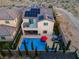 Aerial view shows backyard pool with spa, solar panels, and outdoor lounge area with string lights at 9654 Starfish Reef Way, Las Vegas, NV 89178