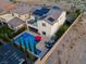 Aerial view showcases backyard pool, lounge area, solar panels, and desert landscaping at 9654 Starfish Reef Way, Las Vegas, NV 89178