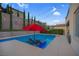 Inviting pool setting with comfortable lounge chairs and shade provided by a large red umbrella at 9654 Starfish Reef Way, Las Vegas, NV 89178