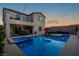 Inviting backyard pool and spa featuring a lounge area, patio dining, and decorative string lights at 9654 Starfish Reef Way, Las Vegas, NV 89178