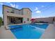 Inviting backyard pool and spa with comfortable lounge seating, perfect for outdoor entertaining at 9654 Starfish Reef Way, Las Vegas, NV 89178