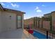 Backyard featuring a pool, patio, privacy landscaping, and distant mountain views at 9654 Starfish Reef Way, Las Vegas, NV 89178