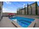 Inviting backyard pool and spa area with lounge chairs and beautiful string lights at 9654 Starfish Reef Way, Las Vegas, NV 89178