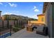 Outdoor rooftop deck features a seating area with fire pit, iron railing, and neighborhood views at 9654 Starfish Reef Way, Las Vegas, NV 89178
