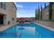 Sparkling swimming pool with integrated jacuzzi, lounge chairs, and a lushly landscaped backyard at 9654 Starfish Reef Way, Las Vegas, NV 89178