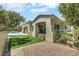 Landscaped backyard with artificial grass, gravel beds and a view of the pool and patio at 10277 Roma Madre Ave, Las Vegas, NV 89135