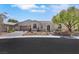 Beautiful single-story home with desert landscaping, mature trees, and brick driveway at 10277 Roma Madre Ave, Las Vegas, NV 89135