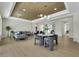 Open concept living room with wood accent ceiling and designer furnishings at 10277 Roma Madre Ave, Las Vegas, NV 89135