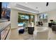 Stylish main bedroom showcasing fireplace, TV, seating area, and outdoor pool through sliding doors at 10277 Roma Madre Ave, Las Vegas, NV 89135