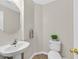 Clean half bathroom featuring a pedestal sink and neutral decor at 11022 Saint Rafael St, Las Vegas, NV 89141