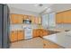 Well-lit kitchen with oak cabinets, tile floors, and modern appliances at 11022 Saint Rafael St, Las Vegas, NV 89141