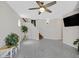 Open-concept living room with gray flooring, staircase, and neutral walls at 11022 Saint Rafael St, Las Vegas, NV 89141