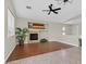 Spacious living room with wood floors, fireplace, and large windows at 11022 Saint Rafael St, Las Vegas, NV 89141