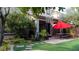 Beautifully landscaped backyard with artificial turf, a patio, and mature trees at 11731 Longworth Rd, Las Vegas, NV 89135