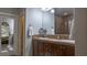 Neutral bathroom features a double sink vanity, large mirror, and tile surround shower at 11731 Longworth Rd, Las Vegas, NV 89135