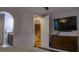 Bedroom with ensuite bathroom and staircase access, along with a mounted TV and dresser at 11731 Longworth Rd, Las Vegas, NV 89135