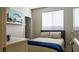 This bedroom offers a cozy space with natural light and a modern decorative shelf at 11731 Longworth Rd, Las Vegas, NV 89135